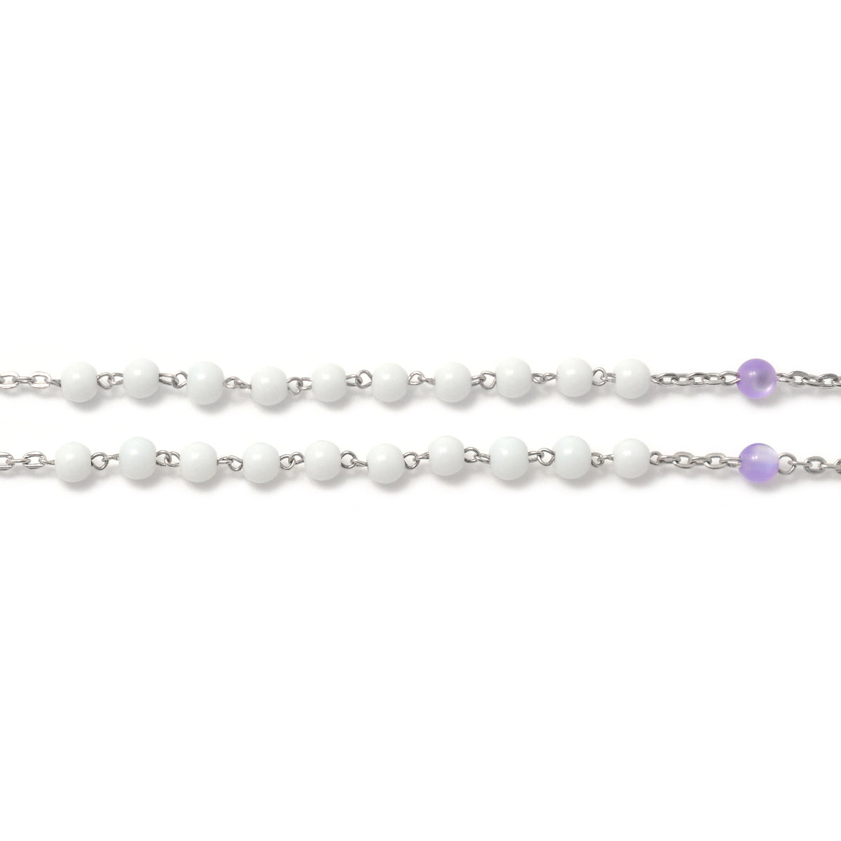 Rosary beads in white and purple colors inspired by the Hallow® brand, elegantly arranged.