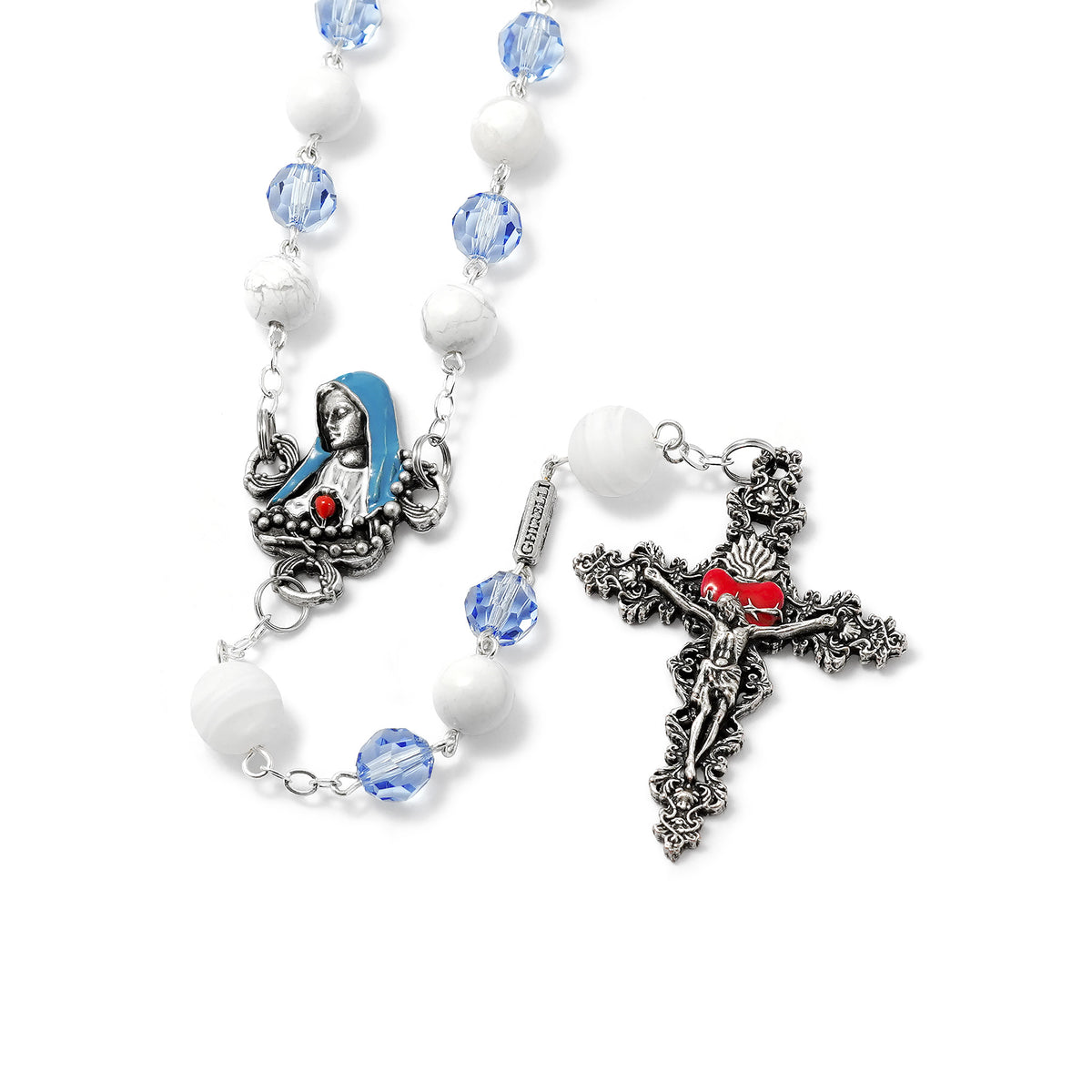 A Our Lady of Fatima Rosary featuring white and blue beads, with a silver crucifix and a centerpiece depicting the Madonna with the Rosary in her hands.