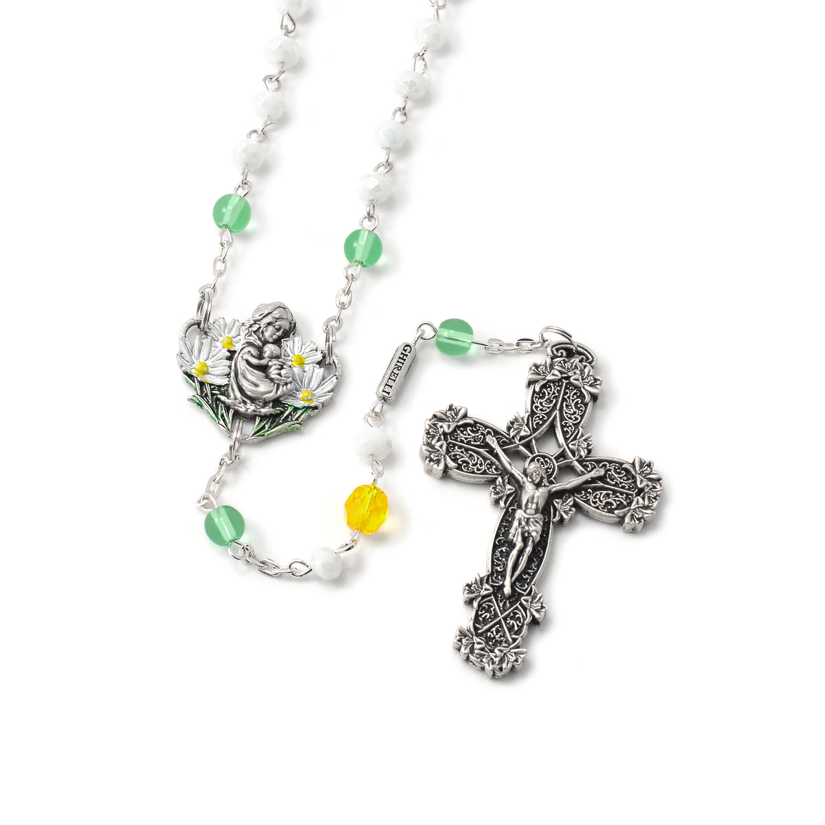 A detailed image of a silver rosary with green, white, and yellow beads, featuring a decorative crucifix and an Our Father bead with a floral centerpiece.