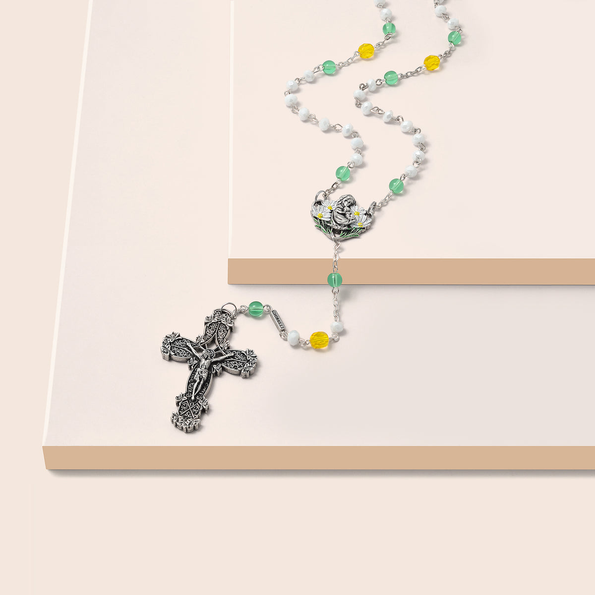 Close-up of Spring Rosary crucifix with hand-painted lilies symbolizing purity