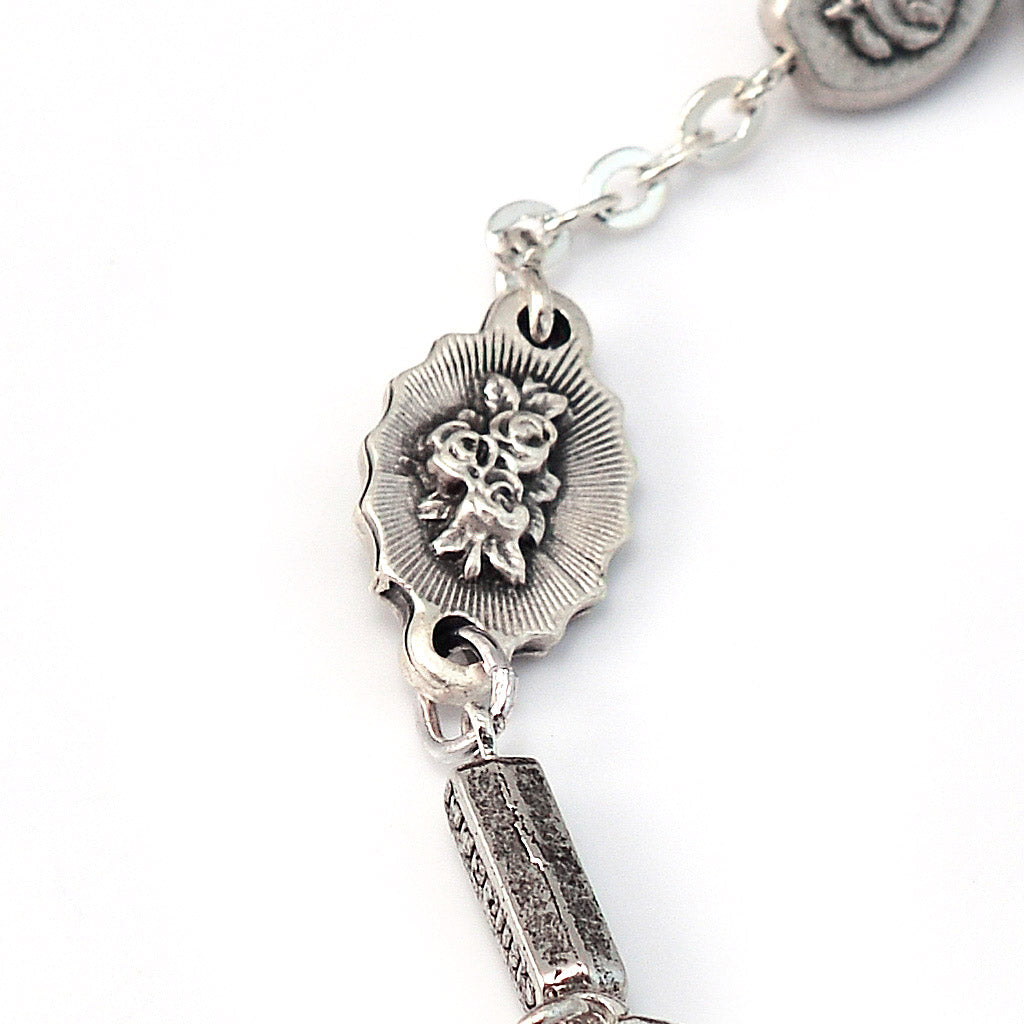 Catholic bracelet featuring Fatima Apparition medals and silver cross pendant