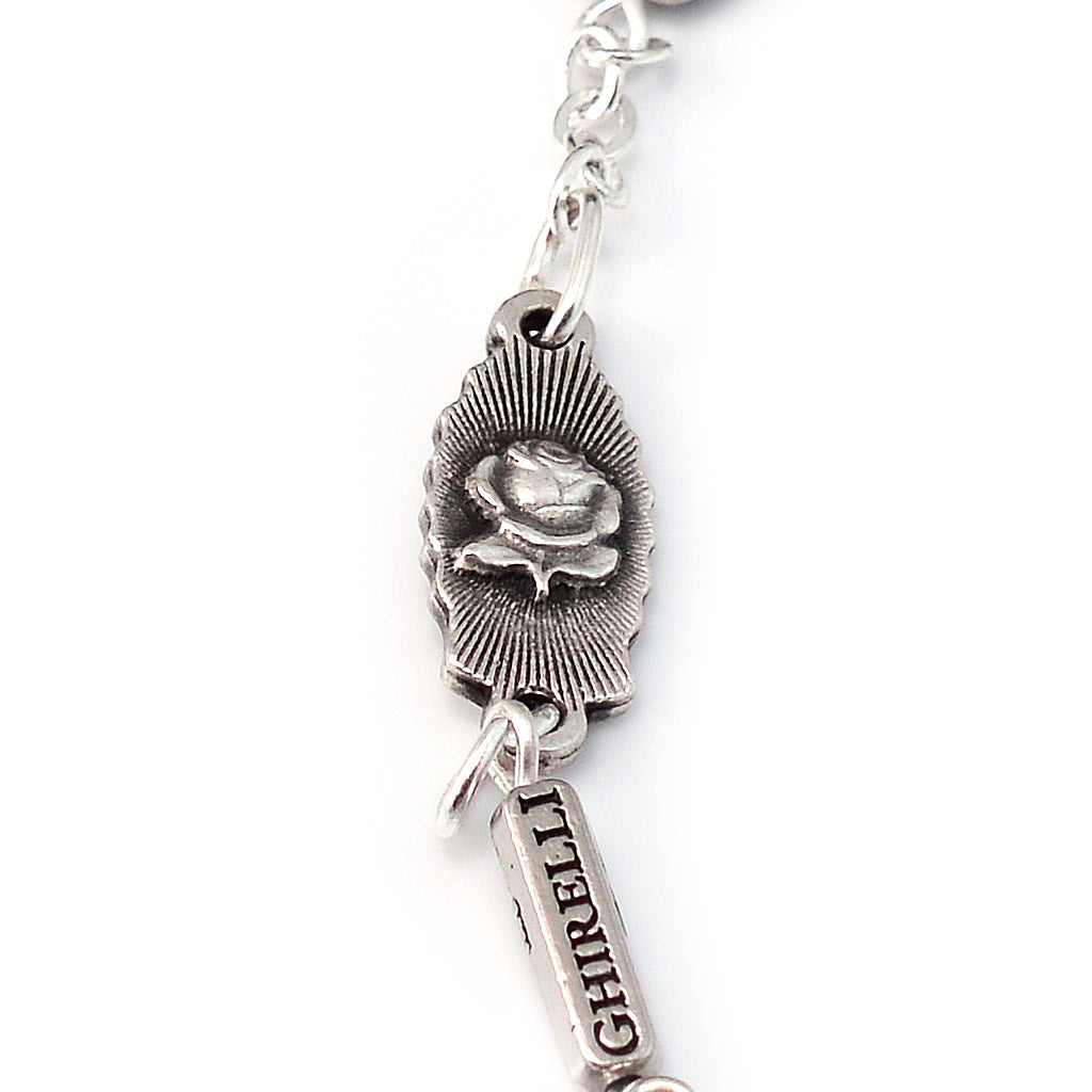 Catholic bracelet featuring Guadalupe medals and Castilian rosebud detail