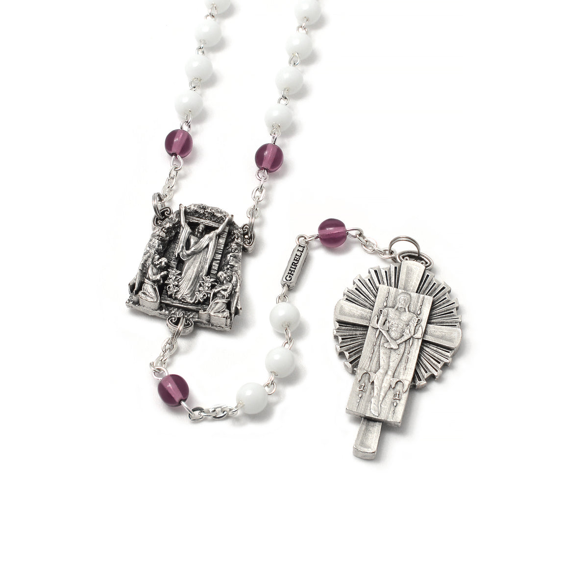 A detailed image of a rosary with white and purple beads, featuring artistic reproductions of the Shroud of Turin and the Resurrection of Christ, with antique silver finish.
