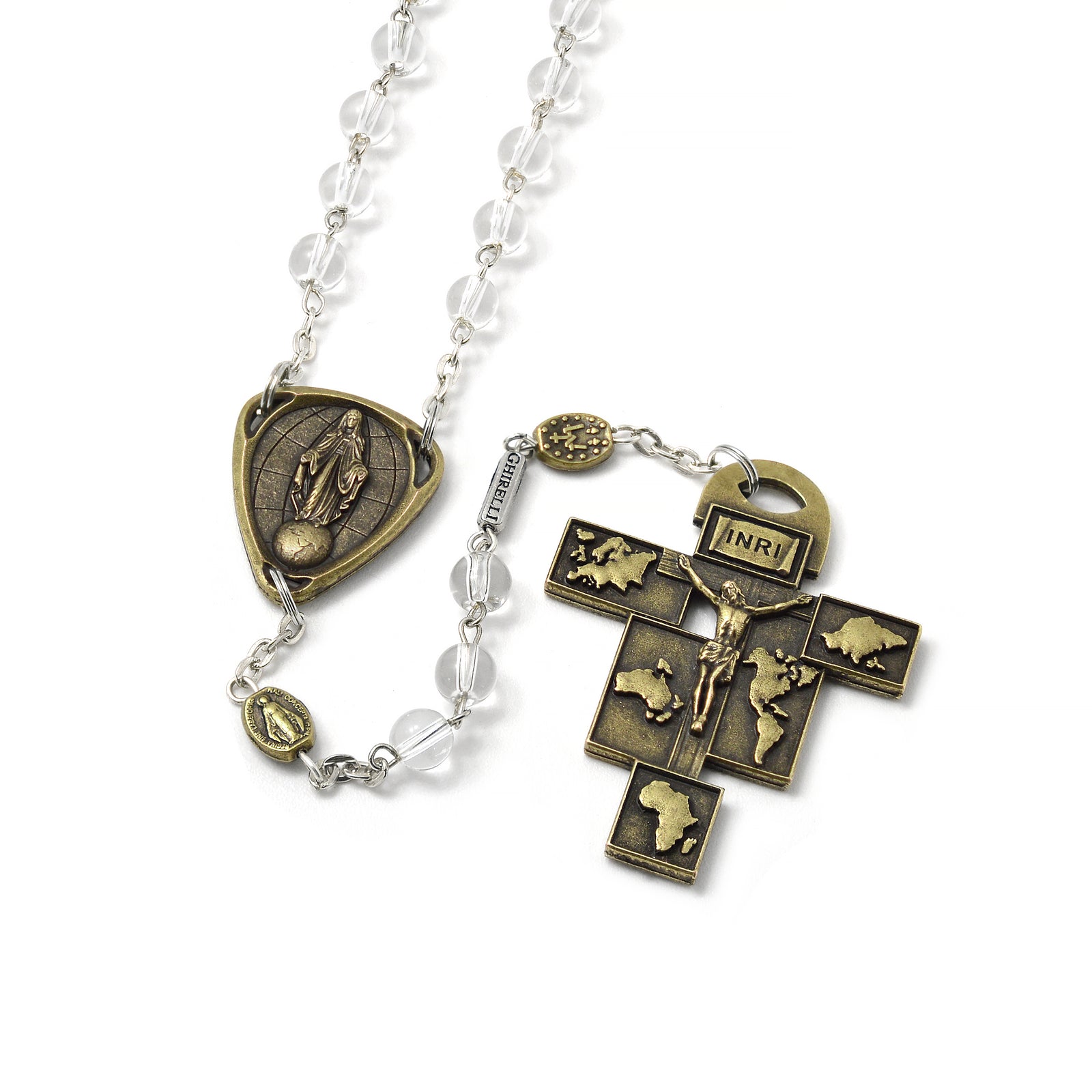 A bronze rosary with clear beads and a Crucifix that features representations of continents. The Crucifix is adorned with the title 'PAX' and the rosary beads include Our Father medals.