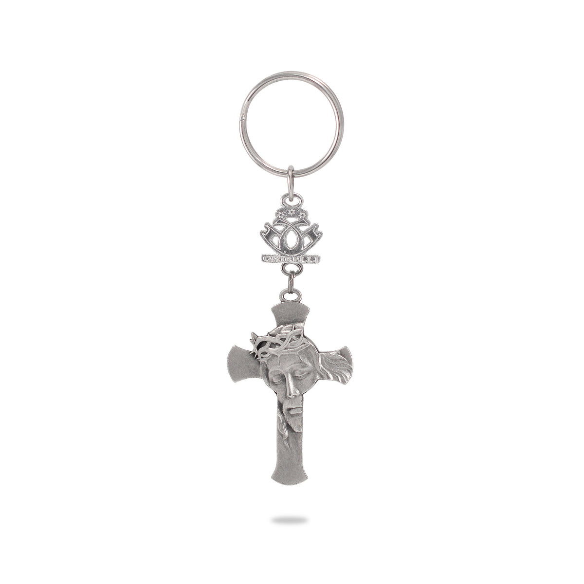 A key chain featuring a silver-colored metal cross with a depiction of Jesus Crucified in the center, attached to a ring and a decorative emblem.