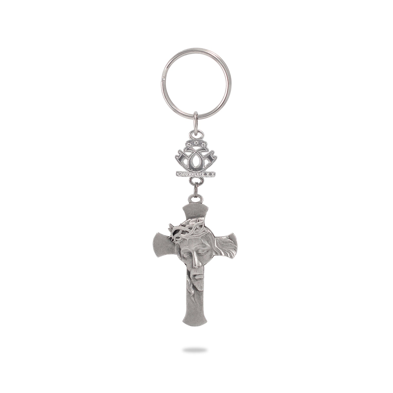 A key chain featuring a silver-colored metal cross with a depiction of Jesus Crucified in the center, attached to a ring and a decorative emblem.